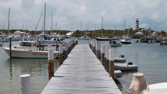 A motorized boat with a seat gliding across the calm water, showcasing a serene aquatic environment.